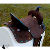 12’’ Double T Barrel style saddle with Oiled Rough out leather Teal buckstitch accents and flower conchos.