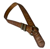 Brown leather belt with brass buckle on a white background