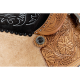 close up Wyoming flower tooling and brown iron conchos saddle